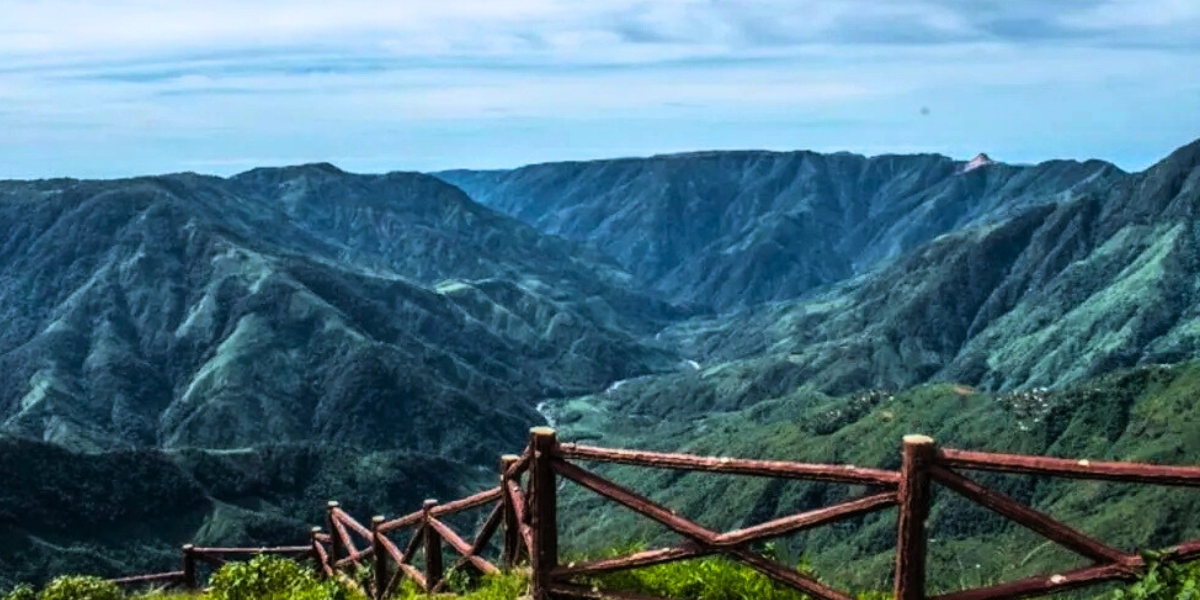 Winding mountain road leading towards Shillong hills